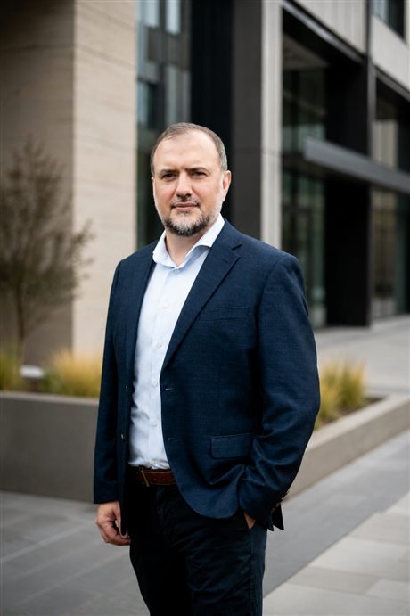 Joseph Birkby, founder of Nomovera, outside a contemporary business building